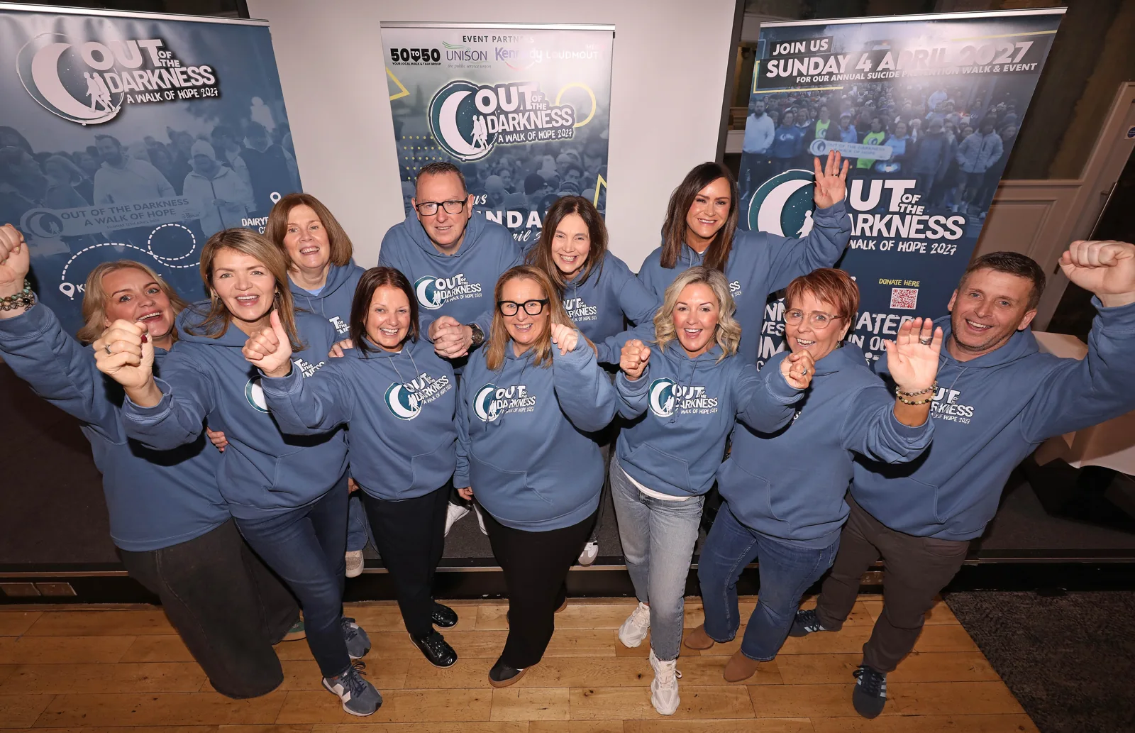 A group of supporters in Out of the Darkness hoodies celebrating at the breakfast morning.